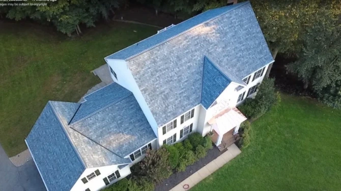 Roofing crew working on brick colonial home in Annapolis Maryland